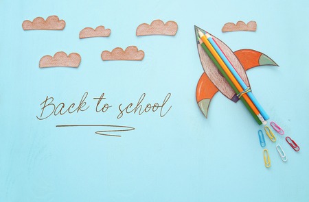 Back to school concept rocket space elements shapes cut from paper and painted over wooden blue background Stock Photo